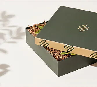Open Packwire rigid gift box with gold foil logo and crinkle paper filler